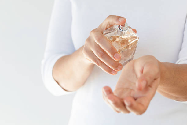 Woman spraying perfume
